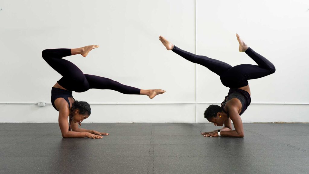 Two women balancing on their arms. Get in touch!