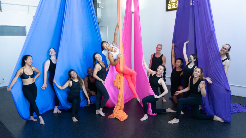 A group having fun playing in the silks