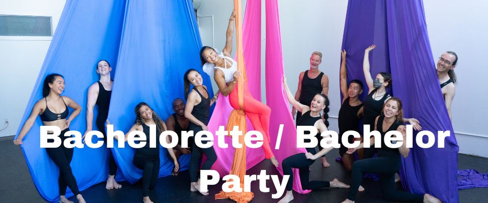 A group of people having fun playing in the silks at a circus themed bachelorette party in Toronto. 