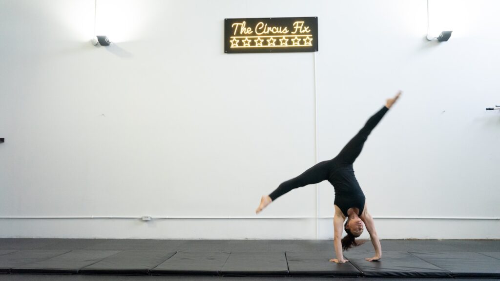 An adult mid cartwheel at Intro to Tumbling