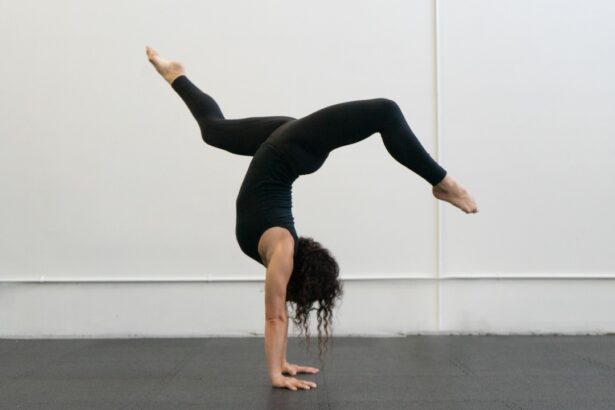 A woman in a handstand with her legs in a stag position