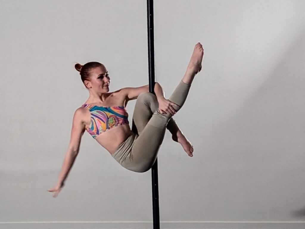 Woman posing on aerial pole