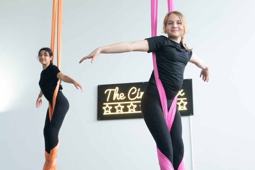 2 youth in the air in silks during drop in class