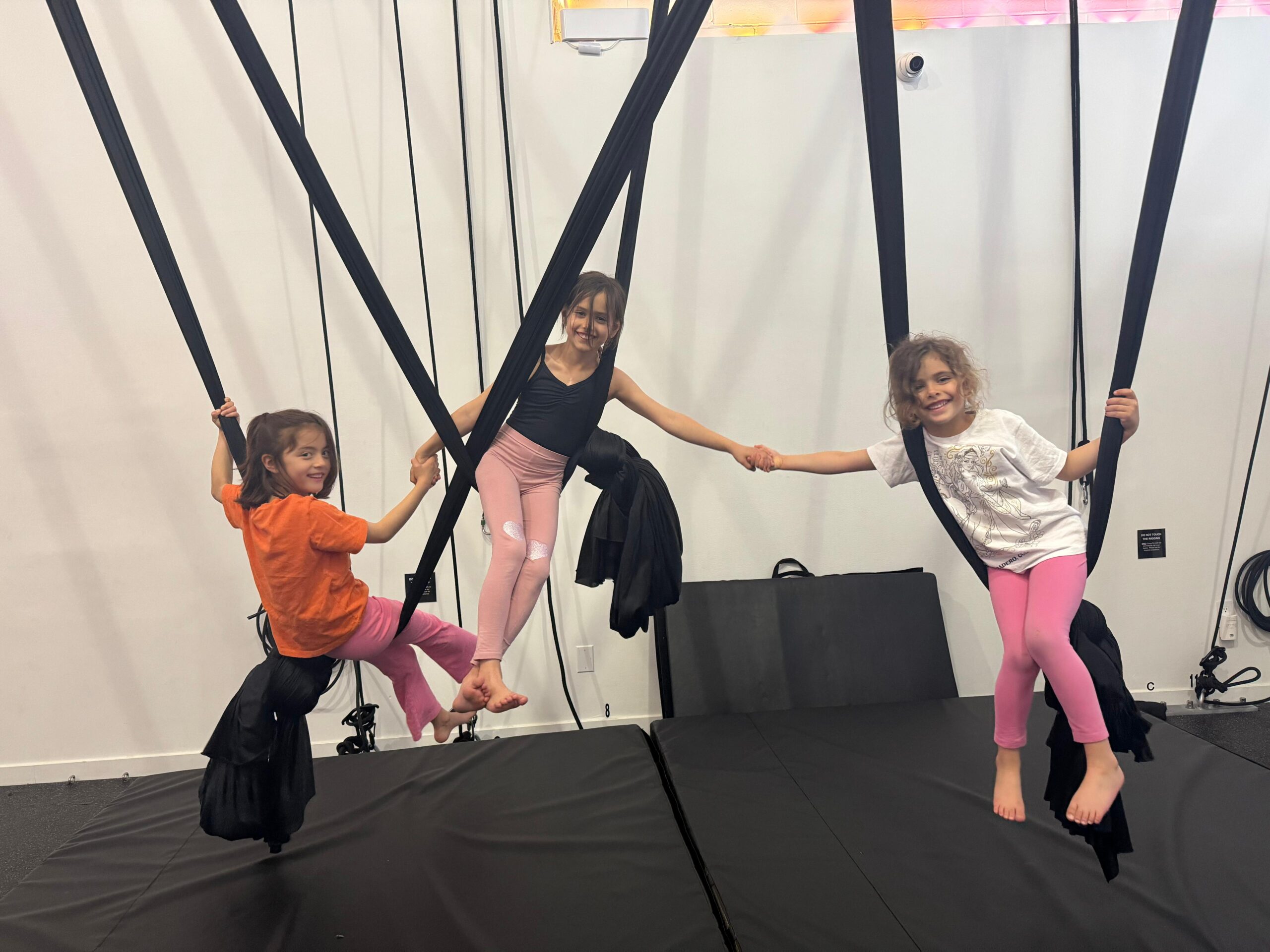 Three younger children playing in hammocks.