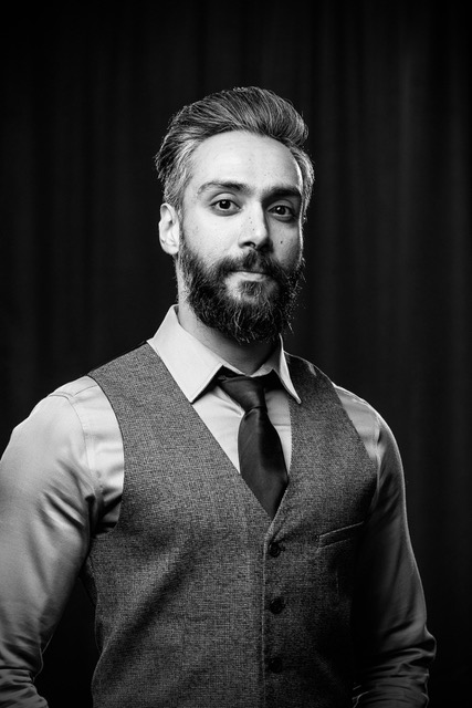 Photo of a man in a vest and tie.