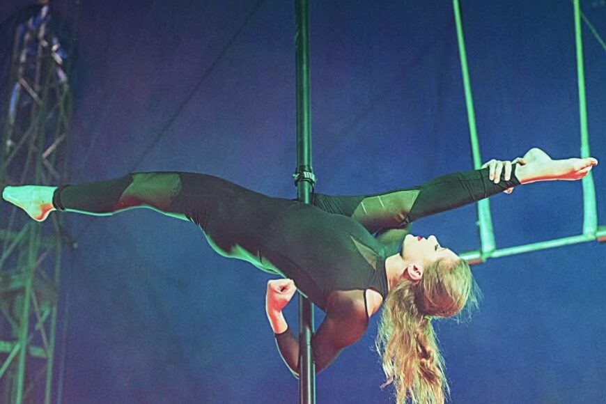 Woman upside down on aerial pole