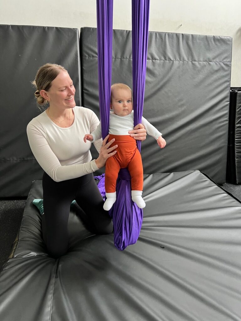 Mom with baby in aerial hammock