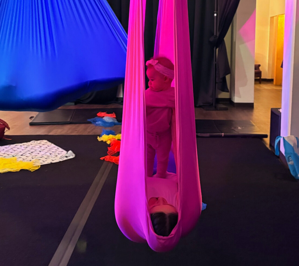 Baby in hammock with mom underneath.
